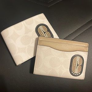 2 matching slim tan coach wallets.